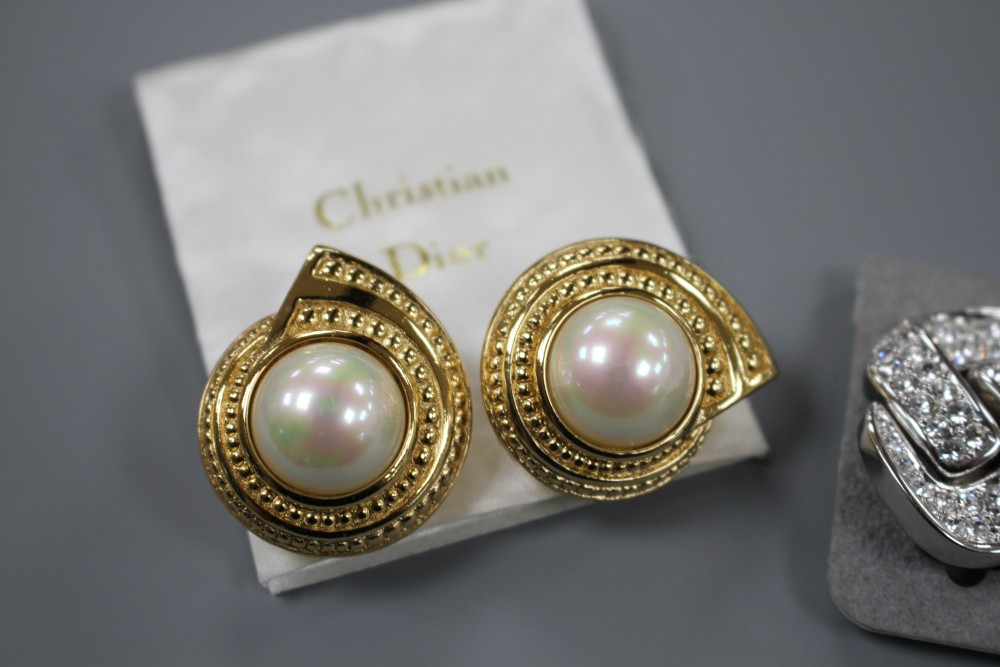 Two pairs of Christian Dior costume ear clips, white paste and simulated pearl, both approx. 33mm, both in Dior boxes.